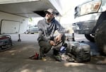 Phil Wheeler repairs his pick-up ahead of him having to leave an encampment on Clackamas Road on Sept. 20, 2024.