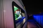 Paramedic Unathi Hayiyana peers out of an ambulance window after arriving at the home of a patient in a high-crime neighborhood in Cape Town. The risk of attack has forced paramedics to adopt a "load and go" approach in many areas — getting a patient in the ambulance as quickly as possible and departing so they spend as little time in the dangerous Red Zones as possible.