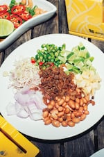 Kai Saam Yang (Chicken Three Ways) does not contain chicken, or meat of any kind – it's just a few raw ingredients piled on a plate. The versions Portlander Andy Ricker came across in northern Thailand did not contain shrimp, either, but he added it for interest.