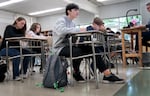 David "DJ" Jennings, center, looks at a projector screen when completing an activity in class at Waldo Middle School in Salem, Ore., on May 19, 2025.