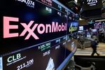 The ExxonMobil logo appears above a trading post at the New York Stock Exchange.