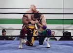 Pro wrestlers "Hotshot" Spencer Scott (left) and Dommatello (right) show off their skills at the Oregon Pro Wrestling School in Hillsboro, Ore. 