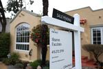 A white "For Sale" sign stands in front of a one-story home in San Anselmo, California, on March 22, 2023.