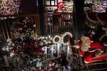 A child looks on from the balcony at a Santa Claus display at Kris Kringl on Tuesday, Nov. 26, 2024, in Leavenworth, Wash.