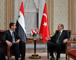 Then-Syrian President Bashar al-Assad (left) talks with Recep Tayyip Erdogan, Turkey's prime minister at the time, during a meeting in Istanbul on June 7, 2010.