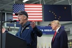 President Donald Trump listens as Sen. Dan Sullivan, R-Alaska, speaks at a campaign rally at the Curtis D. Menard Memorial Sports Center, Tuesday, Oct. 13, 2026, in Wasilla, Alaska.