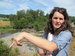 Amanda Cronin stands near the Dungeness River downstream from where water could be diverted during higher flows to fill a reservoir.