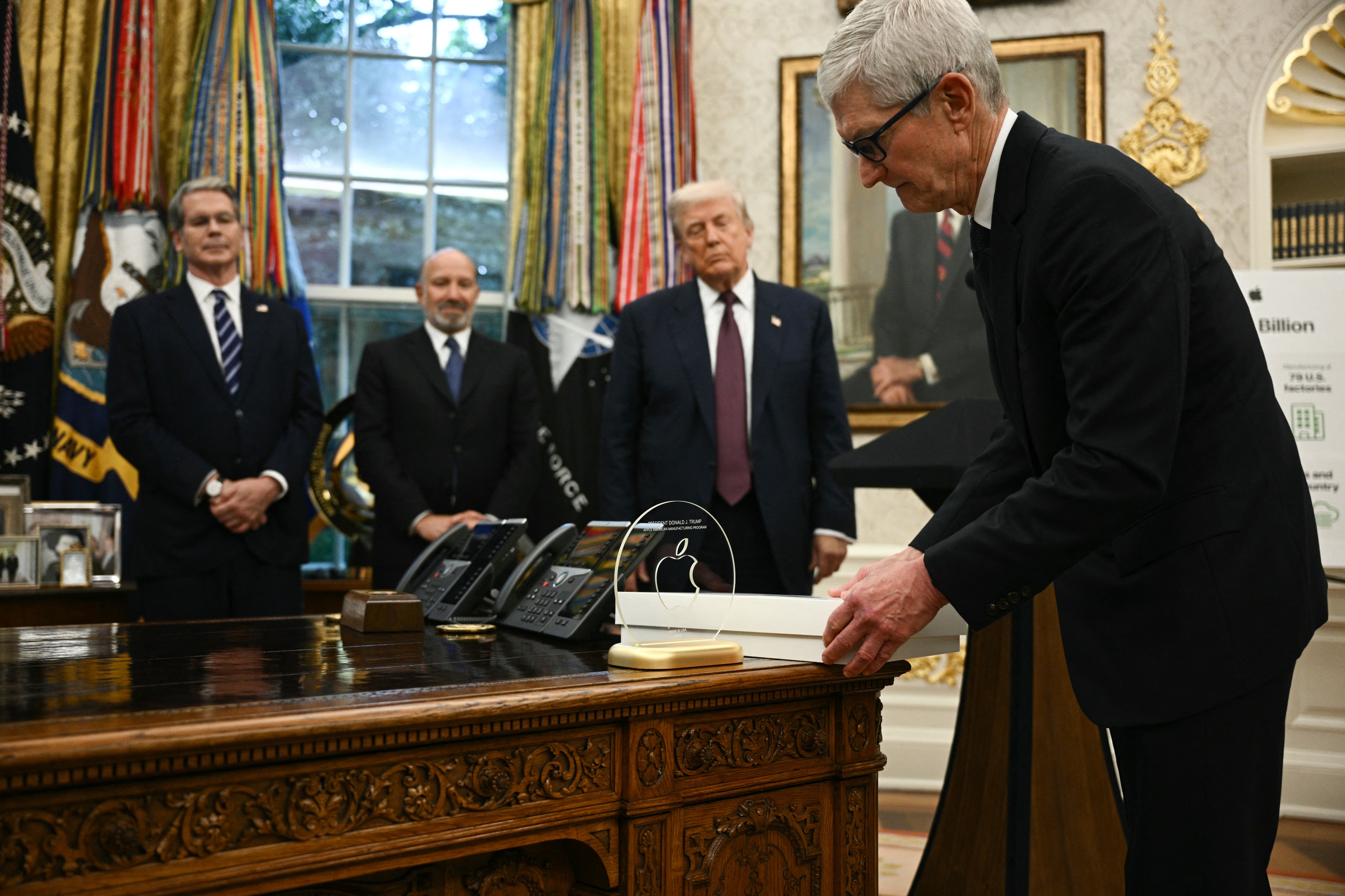 In August, Apple CEO Tim Cook presented President Trump with a gold-plated and glass plaque, as his company pledged to invest a total of $600 billion in the United States.