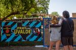 Siblings Kiley and Michael Regenthal pay their respects at a memorial in front of Robb Elementary School on June 17, in Uvalde, Texas.