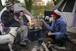 Mike Dusek, Chris Drake, and Raven Drake at their camp on I-5 in North Portland. Drake, a former Navy Corpsman, set up a makeshift medical tent at her camp to help take care of her camp mates and anyone else who might need medical help during the coronavirus pandemic.