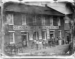 This photograph shows Geo. Abernethy  Wholesale Store, Oregon City's first brick building, circa 1850s.