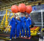 In this photo provided by NASA, from left, NASA astronauts Reid Wiseman, commander;  Christina Koch, mission specialist; CSA (Canadian Space Agency) astronaut Jeremy Hansen, mission specialist; and NASA astronaut Victor Glover, Artemis II pilot, right, pose for a group photo after viewing the Orion spacecraft in the well deck of USS John P. Murtha, Saturday, April 11, 2026, in the Pacific Ocean off the coast of California.