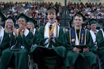 FILE - Ethan Myers, center, and Ian Franks, left, yell after a name was announced as graduates received their diplomas during Estacada High School’s graduation ceremony on June 13, 2026. On-time high school graduation is one of the education indicators the Annie E. Casey Foundation report uses to calculate child well-being in Oregon.