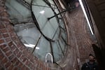 John Pohlpeter looks at the western face of the Union Station clock tower in Portland on March 9, 2024. The clock, completed in 1895, has several chips and cracks on the inside.