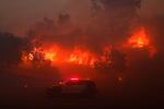 Fire burns a property in the Pacific Palisades neighborhood of Los Angeles.