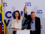 Opposition presidential candidate Edmundo Gonzalez, right, and opposition leader Maria Corina Machado join hands during a press conference the day after the election in Caracas, Venezuela, Monday, July 29, 2024.