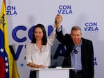 Opposition presidential candidate Edmundo Gonzalez, right, and opposition leader Maria Corina Machado join hands during a press conference the day after the election in Caracas, Venezuela, Monday, July 29, 2024. 