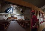 Adam Monfort, a restoration technician for Belfor Property Restoration, looks over damage to the sanctuary First Congregational United Church of Christ as crews work at the building Thursday morning, May 26, 2016.