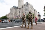 National Guard troops walk across the street from the Waldorf Astoria hotel where President Donald Trump attended the White House Correspondents' Association Dinner, in Washington, Friday, July 24, 2026. (AP Photo/Cliff Owen)