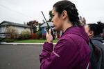 Izza Dye, dean of students at J.W. Poynter Middle School, communicates with other volunteers during the ICE watch on Friday, Oct. 24, 2025 in Hillsboro, Ore. The watch, which happens during school drop-off, is an informal effort started by educators and parents in response to increased ICE activity in the area.