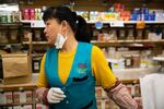 Zhong Yz works behind the counter at Wing Ming Herbs in Portland, Ore., Tuesday, Feb. 18, 2020.