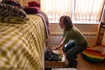 Lucy Lunceford puts clothes away at her dorm. The freshman, whose family lives only a mile away, elected to stay in the dorms even though it isn't a requirement for students who live near campus. 