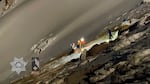 Several people with headlamps surround an injured woman on Mount Hood as night falls