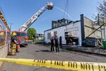 Portland Fire crews continue to put water on hot spots at the Portland Garment Factory at southeast 79th and Stark, where crews responded early morning on April 19, 2021 for a construction fire. No one was injured in the three-alarm blaze.