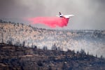 An air tanker drops retardant while battling the Bench fire on Saturday, July 25, 2026, in Jefferson County, Ore.