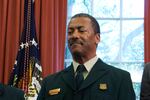 FILE - In this July 10, 2015, file photo Randy Moore, of the U.S. Forest Service, listens as President Barack Obama talks about the designation of three new national monuments in the Oval Office of the White House in Washington. Veteran forester Randy Moore has been named chief of the U.S. Forest Service, the first African American to lead the agency in its 116-year history.
