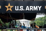 Workers set up the reviewing stand in front of the White House on June 10 for the U.S. Army's 250th anniversary parade.