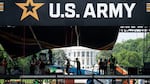 Workers set up the reviewing stand in front of the White House on June 10 for the U.S. Army's 250th anniversary parade.