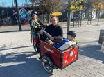 Lelac Almagor and two of her children take NPR's Adam Bearne for a ride in their e-cargo bike.