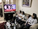 Women watch an Al Jazeera obituary report on TV at the family home of Al Jazeera journalist Shireen Abu Akleh in the Palestinian neighborhood of Beit Hanina in Israeli-occupied east Jerusalem on Wednesday, after she was killed as she covered an Israeli army raid on Jenin refugee camp in the occupied West Bank.
