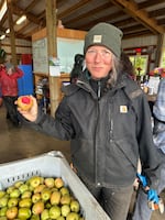 Farmer Rachel Ashley taking a bite out of a Airlie Red Flesh apple during a cider pressing at RainShine Family Farm, which she owns with husband Elias Silvernail. Kings Valley, Ore. October 21, 2024.