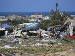 People look for salvageable items following an Israeli raid in Rafah's al-Mawasi area in the southern Gaza Strip, June 29.