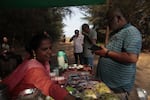 Visitors buy snacks after watching turtle hatchlings crawl to the shore by the western Indian village of Velas.