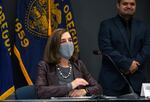 Oregon Gov. Kate Brown attends a news conference Tuesday, Nov. 10, 2020, in Portland, Ore. Brown and Oregon health officials warned Tuesday of the capacity challenges facing hospitals as COVID-19 case counts continue to spike in the state.