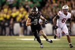 Oregon tight end Terrance Ferguson, left, runs the ball downfield against Ohio State safety Sonny Styles (6) during an NCAA college football game, Saturday, Oct. 12, 2024, in Eugene, Ore.