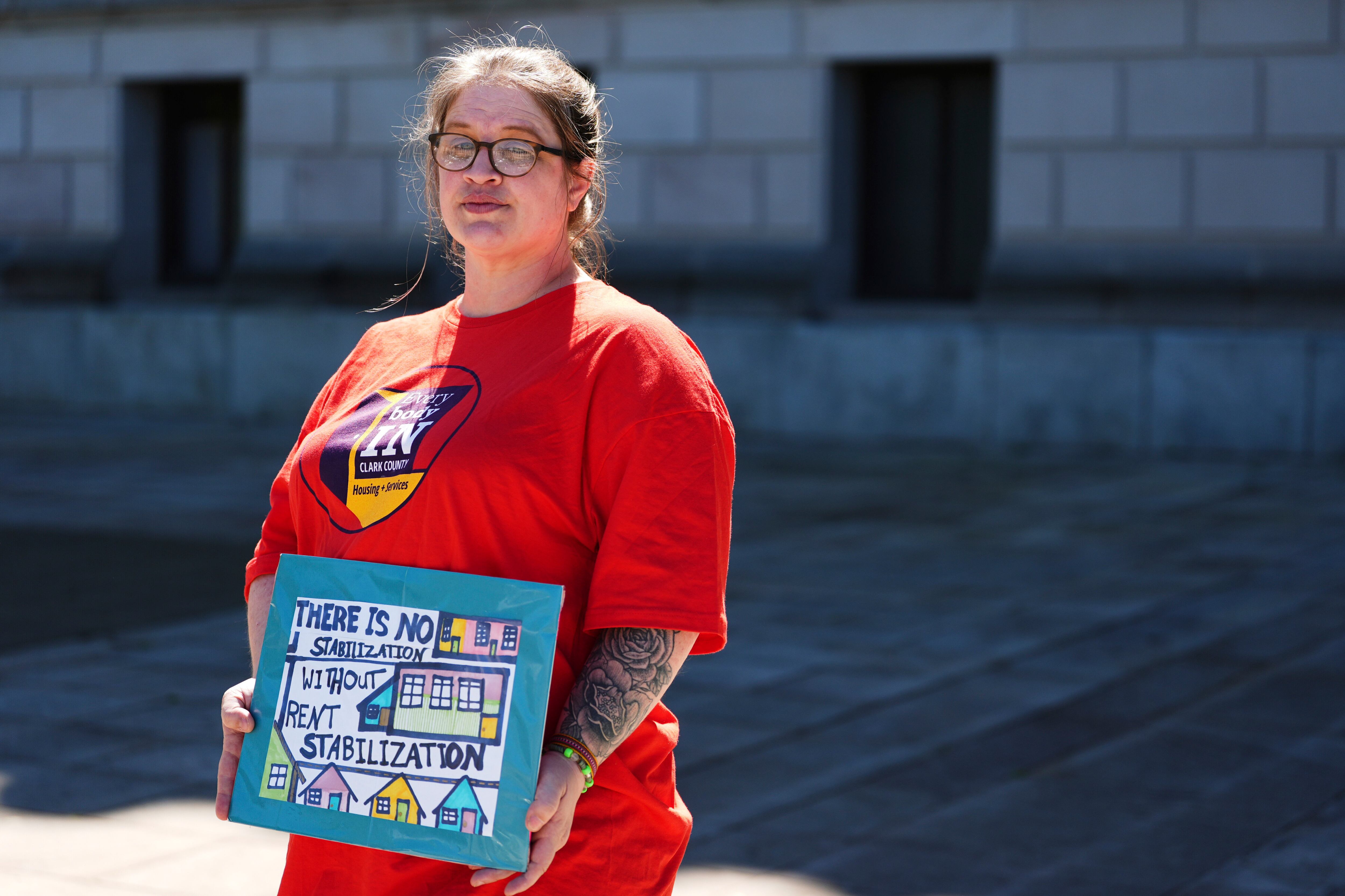 Dominique Horn, a renter in Camas, Wash., who says she's paying half her income for rent, pose for a portrait during a rally advocating for lawmakers to change and pass House Bill 1217.
