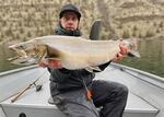 Ryan Mejaski of Bend, Ore., holds a bull trout that he caught on April 8, 2023, in Lake Billy Chinook.
