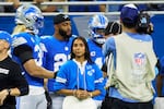 Detroit Lions linebacker Alex Anzalone (34) and Honorary caption Diana Flores, Flag Football Ambassador, on the sideline before the game against the Tampa Bay Buccaneers an NFL football game in Detroit, Sunday, Sept. 15, 2024. (AP Photo/Rick Osentoski)