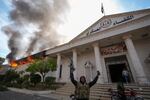 FILE - Opposition fighters celebrate as a military court burns in Damascus, Syria, on Sunday, Dec. 8, 2024.