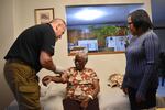 The Medicare and Medicaid waiver that makes the hospital-at-home program possible expires on Dec. 31, 2024. Congress could extend it. Stephanie Joseph's daughter Ketline Edouard, right, helps paramedic Shane McMahon care for her mom.