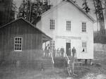 In this image from 1892, residents stand outside the Coos County, Ore., Infirmary, which operated as a local poor farm.
