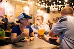 Michelle Webster (left), who grew up in Washington State, watches the Seattle Seahawks game against the Denver Broncos at Red Bear Brewing in Washington, D.C. on Sept. 12.