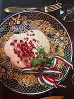 Chiles en nogada, a traditional dish that is eaten in Mexico from August to early October. Made from poblano peppers, stuffed with meat, pears, peaches, pine nuts and sometimes — but not in this case — acitrón, and bathed in nogada, a walnut cream sauce, and garnished with pomegranate seeds and parsley.