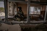 A Ukrainian serviceman stands in a heavily damaged building in Stoyanka, Ukraine, Sunday, March 27, 2022. Ukrainian President Volodymyr Zelenskyy accused the West of lacking courage as his country fights to stave off Russia's invading troops, making an exasperated plea for fighter jets and tanks to sustain a defense in a conflict that has ground into a war of attrition.