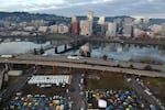 FILE - In this aerial photo, tents housing people experiencing homelessness are set up on a vacant parking lot in Portland, Ore., Dec. 8, 2020.