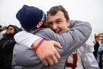 Central Catholic lineman Joe Merlino (64) hugs friends and family at the end of the game. The Central Catholic Rams played the Lake Oswego Lakers at Hillsboro Stadium in Hillsboro, Oregon, on Dec. 7, 2019. The Rams defeated the Lakers 49-28.